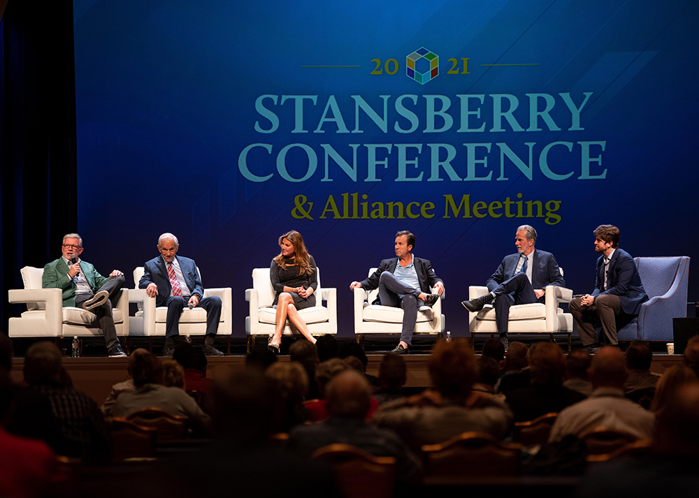 Image of speakers on stage at previous conference